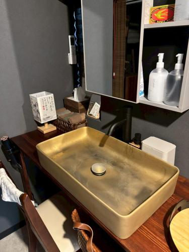 a stainless steel sink sitting on a wooden table at 旅籠小龍 in Kochi