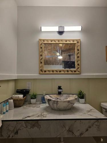 a bathroom with a large stone sink and a mirror at Dawson House Lodge in Chemult