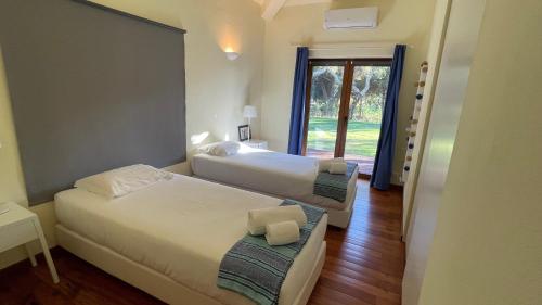 a hotel room with two beds and a window at Branca Countryside Retreat in Coruche