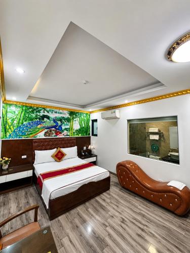 a bedroom with a bed and a painting on the wall at Hoàng Gia Long Biên Hotel in Hanoi