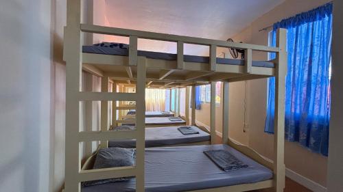 a row of bunk beds in a room at Buku island in san juan la union