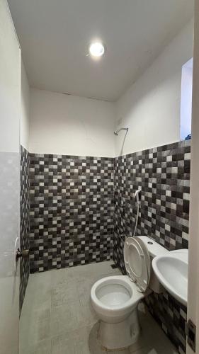 a bathroom with a toilet and a sink at Buku island in san juan la union