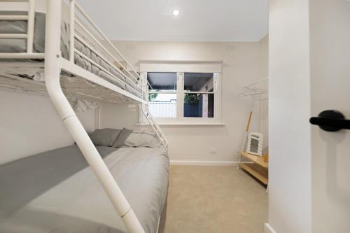 a bedroom with a bunk bed and a window at The Ironbark Nest in Bendigo
