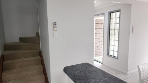 a staircase in a house with a stair case at The Goose Ponds in North Mackay