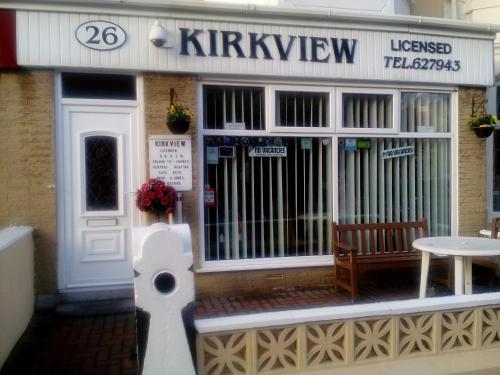 a coffee shop with a bench in front of it at The Kirkview in Blackpool