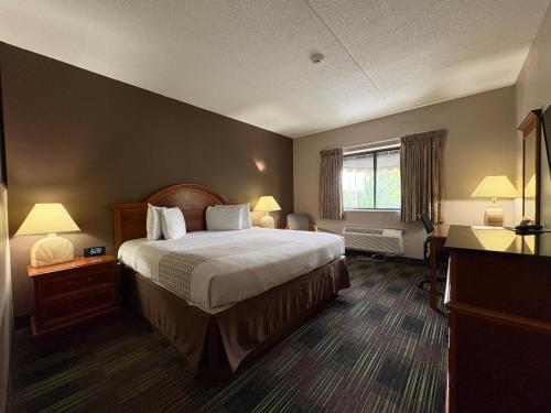 a hotel room with a bed and a window at South Shore Inn in Sandusky