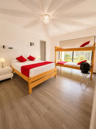 a bedroom with two beds and a bunk bed at Finca Hotel Estrella del Eden in Armenia