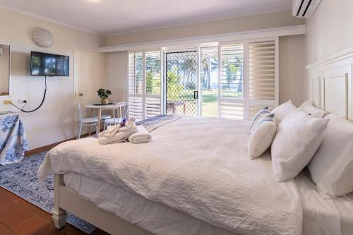 a bedroom with a large bed with towels on it at The Sunset Sea in Eimeo