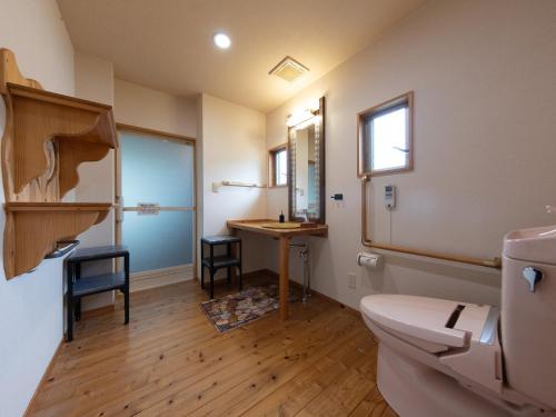 a bathroom with a toilet and a sink at Yufuin Onsen 8A1 Yaeichi in Yufu
