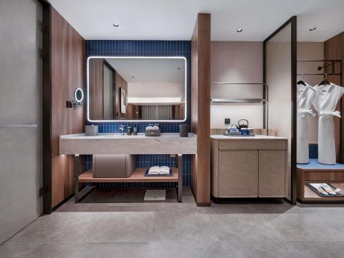 a bathroom with a sink and a mirror at Novotel Hangzhou Binjiang in Hangzhou