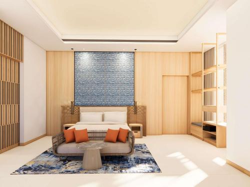 a bedroom with a bed and a couch at Mövenpick Resort Carita in Serang