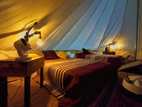 a bedroom with two beds in a tent at Chantli Nawi Glamping & Temazcal in Ixtafiayuca