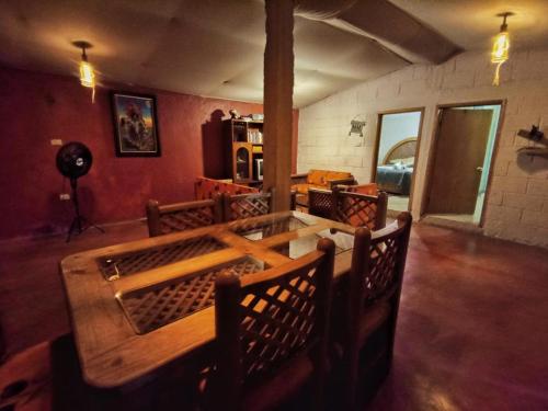 a dining room with a wooden table and chairs at Chantli Nawi Glamping & Temazcal in Ixtafiayuca