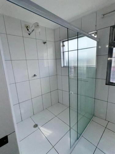 a bathroom with a shower with a glass door at Hotel Divisa poá in Poá