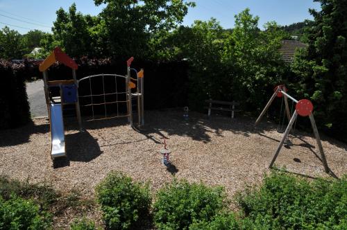a childrens playground with a swing set at Résidence Thier Antoine in Noiseux