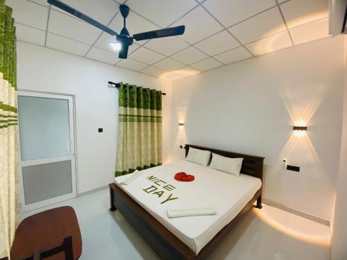 a bedroom with a bed and a ceiling fan at New Vilard in Tissamaharama