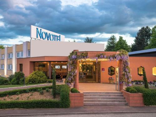 a building with an entrance to a novation sign at Novotel Macon Nord - Porte de Bourgogne in Mâcon
