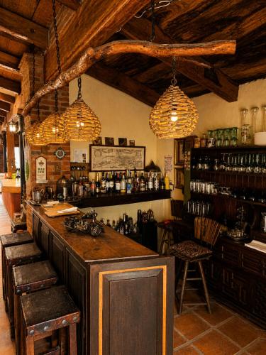 a bar in a room with chairs and lights at Chalet Ojo de Agua in Jilotepec de Abasolo