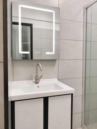 a bathroom with a sink and a mirror at Alina Ridge in Nairobi