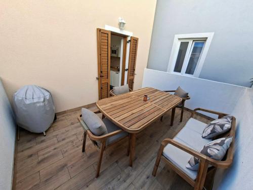 a small room with a wooden table and chairs at Vacation home Dora in Baška