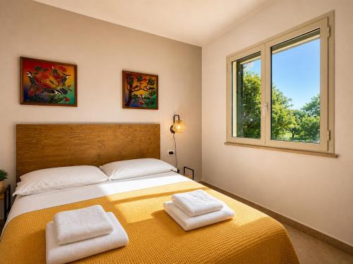 a bedroom with a bed with two towels on it at Agriturismo Il Querciolo in Grosseto