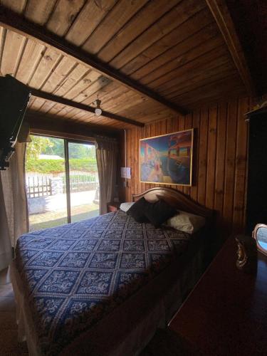 a bedroom with a bed in a wooden room at Spacious Beach House with Pool for Relaxing in El Quisco