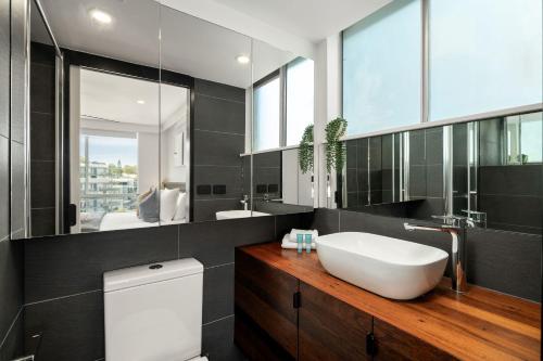 a bathroom with a white sink and a toilet at Burleigh Beach Tower in Gold Coast