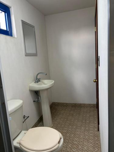 a bathroom with a toilet and a sink at Hotel Casa Don Marcos in Ixtafiayuca