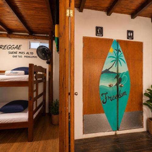 a door to a room with a surfboard on the wall at Freedom Beach Club in Barú