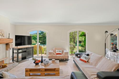 a living room with a couch and a table at Provencal Villa With Pool In Collobrières in Contre