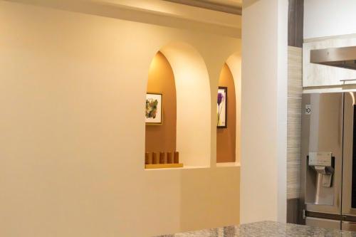 a kitchen with three arches on the wall at Hotel Scarlette in Tulum