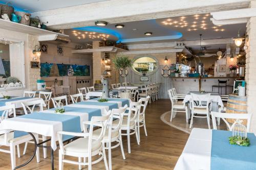 a restaurant with blue and white tables and chairs at Penzion Na Palubě in Mikulovice