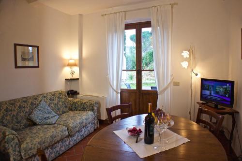 a living room with a couch and a table at Podere Dell'Anselmo in Montespertoli