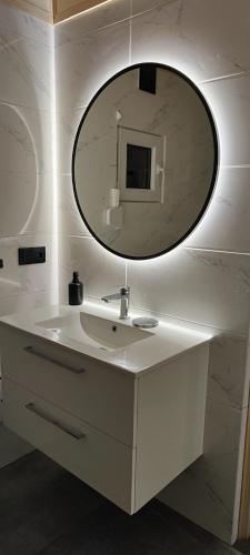 a bathroom with a white sink and a mirror at Odpoczynkowo in Orle