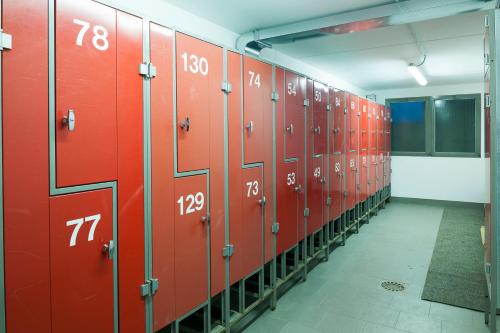 a row of red lockers in a locker room at Residence Bait da Mott in Livigno