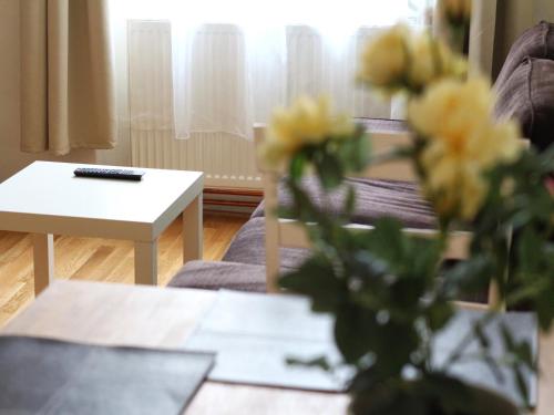 a living room with a vase of flowers on a table at Old Town Home Prague in Prague