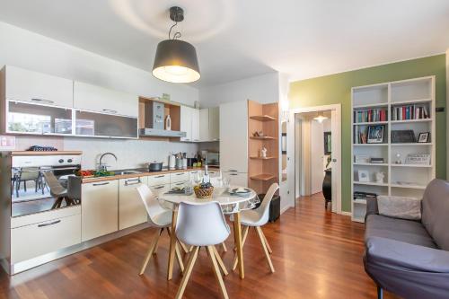 a kitchen and living room with a table and chairs at Suite 22 - Happy Rentals in Riva del Garda