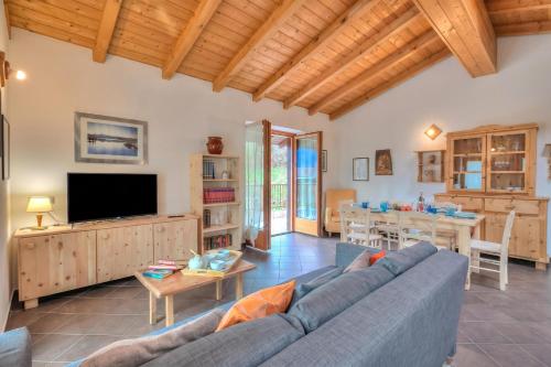 a living room with a blue couch and a table at Casa Tra Borgo e Lago in Lake Tenno - Happy Rentals in Tenno