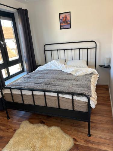 a bed in a bedroom with a rug and a window at O21 Apartment in Amersfoort