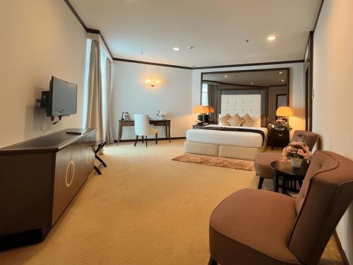 a hotel room with a bed and a television at Adya Hotel Kuah Langkawi in Kuah