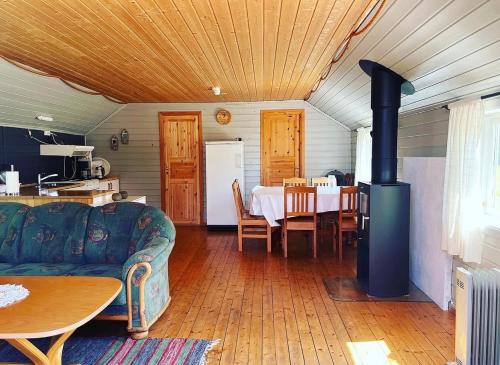 a living room with a couch and a stove at Bakerstu in Skage i Namdalen