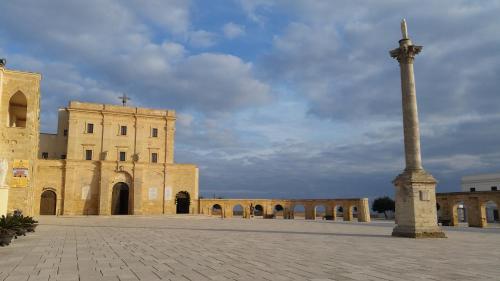 a large building with a pole in front of it at Masseria Ruri Pulcra in Patù
