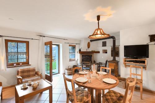 a living room with a table and a dining room at Rustico Alla Bolla - Val Verzasca - Happy Rentals in Frasco