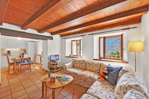a living room with a couch and a table at Rustico Esterina in Val Verzasca for 4 - Happy Rentals in Lavertezzo