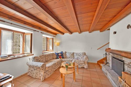 a living room with a couch and a fireplace at Rustico Esterina in Val Verzasca for 4 - Happy Rentals in Lavertezzo