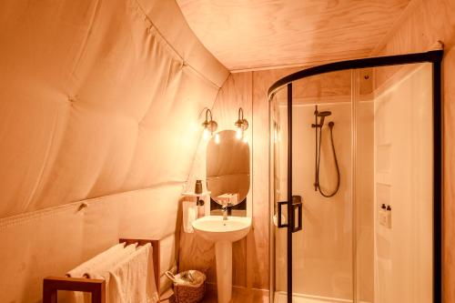 a small bathroom with a sink and a shower at Valley Views Glamping in Kurow