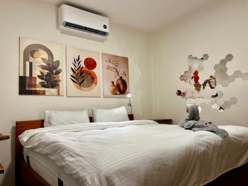 a bedroom with a large bed with a white bed sqor at Farm Village in San Juan