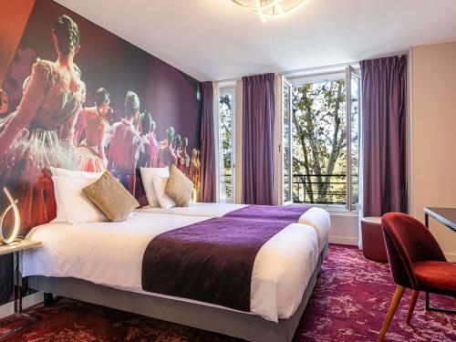 a bedroom with a large bed with a painting on the wall at Mercure Paris Place d'Italie in Paris
