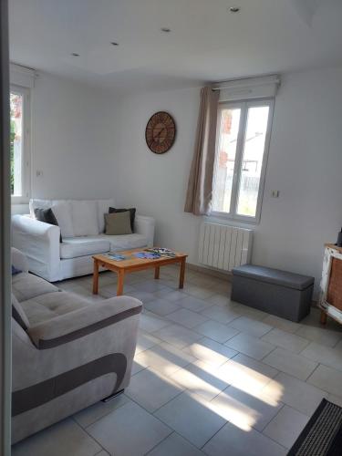 a living room with a couch and a table at Garde barrières N 22 in Cholet