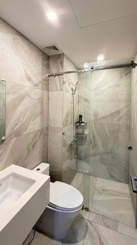 a bathroom with a toilet and a glass shower at LeeThuyhomePR86 in Kinh Dinh